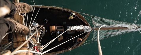 Miniature autonomous sailboat collecting ocean data, revolutionizing marine science with innovative technology.